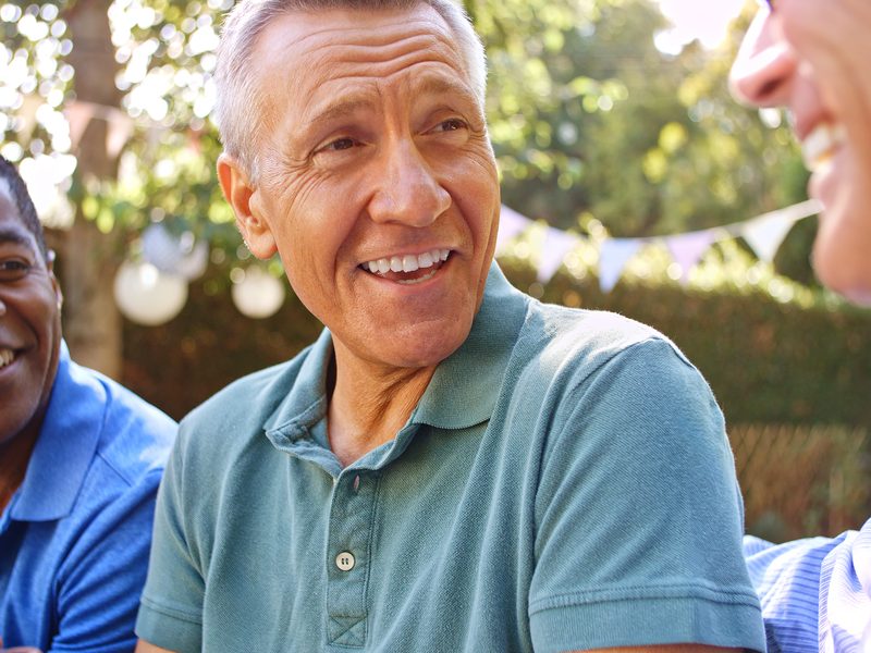 Older men talking warmly in a community space